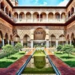 Interior photo of The Royal Alcázar of Seville, showcasing intricate Mudejar architecture and tilework
