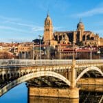 Golden sandstone buildings of Plaza Mayor in Salamanca, Spain at sunset