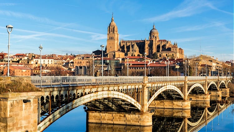 Golden sandstone buildings of Plaza Mayor in Salamanca, Spain at sunset