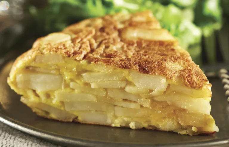 Traditional Spanish tortilla Española – classic potato omelette with eggs, onions, and olive oil served on a rustic table, authentic Spanish cuisine from Spain.